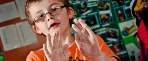 Child having fun with paint on their hands